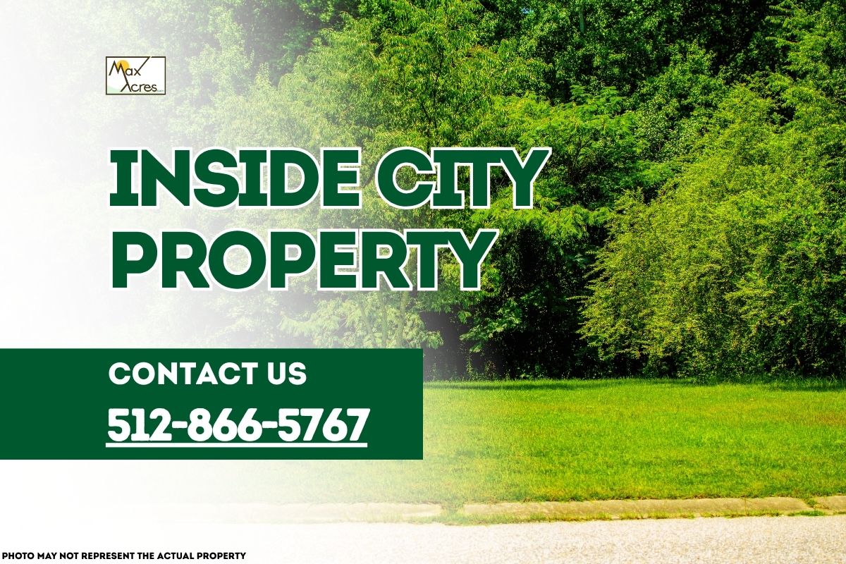 Green open lot within city limits with text overlay reading "Inside City Property – Contact 512-866-5767" by Max Acres.
