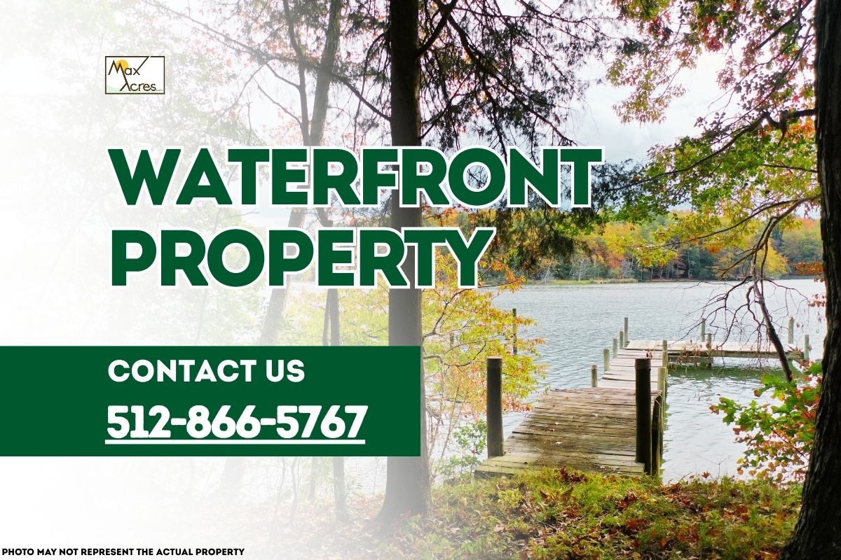 Max Acres promotional banner for waterfront property featuring a wooden dock extending into a calm lake surrounded by trees, with contact number 512-866-5767